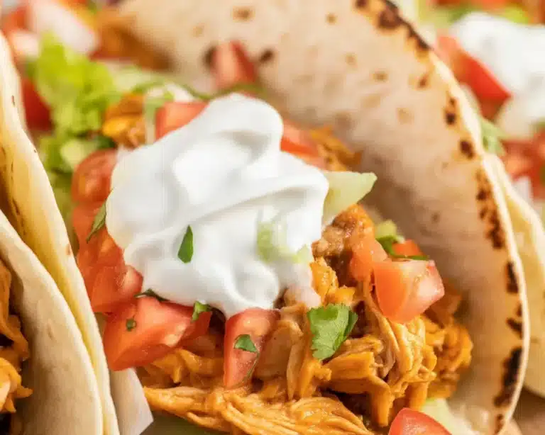 Easy shredded chicken tacos served in warm tortillas with fresh toppings.