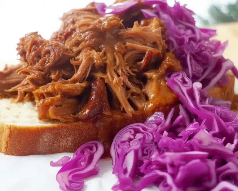 Delicious Christmas pulled pork with cranberry sauce garnished for a festive feast.