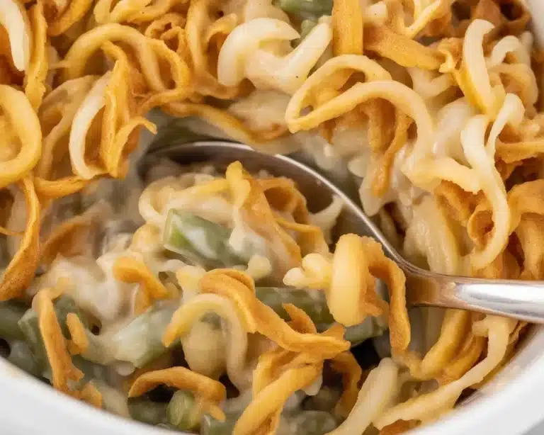 Delicious slow cooker green bean casserole topped with crispy fried onions.