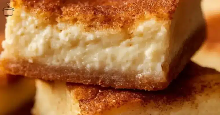 Delicious crescent cheesecake bars topped with a creamy layer and flaky pastry.