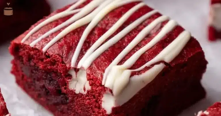 Delicious Red Velvet Brownies topped with creamy frosting on a plate