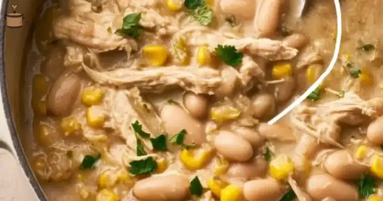 Bowl of white chicken chili topped with cilantro and cheese