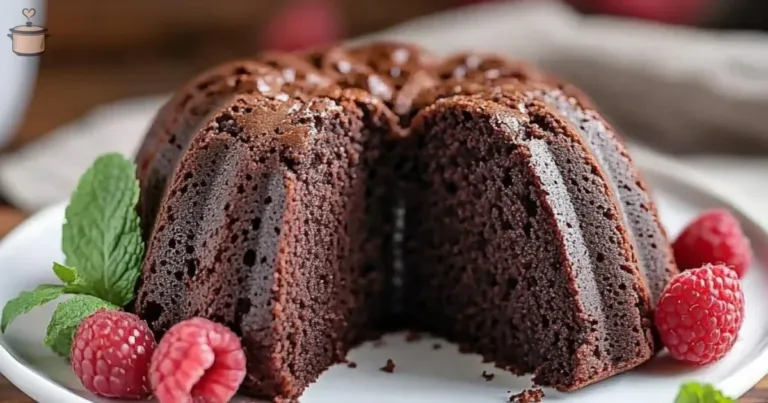 Delicious Kahlua Bundt Cake topped with chocolate glaze on a white plate.