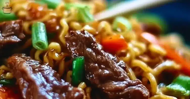 Bowl of slow cooker beef ramen noodles topped with green onions and cilantro