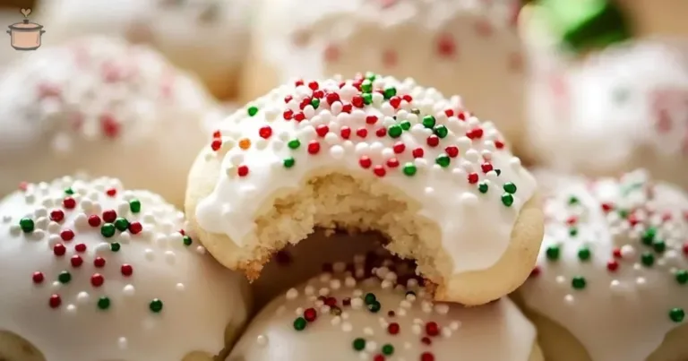 A plate of traditional Italian Christmas cookies decorated with festive icing.