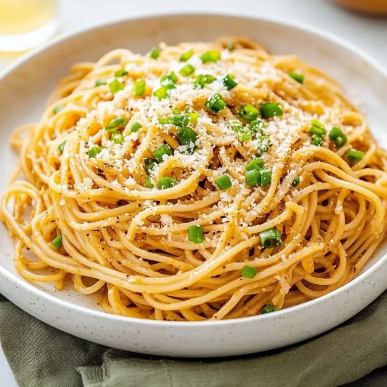 Bowl of Vietnamese Garlic Noodles garnished with herbs and garlic