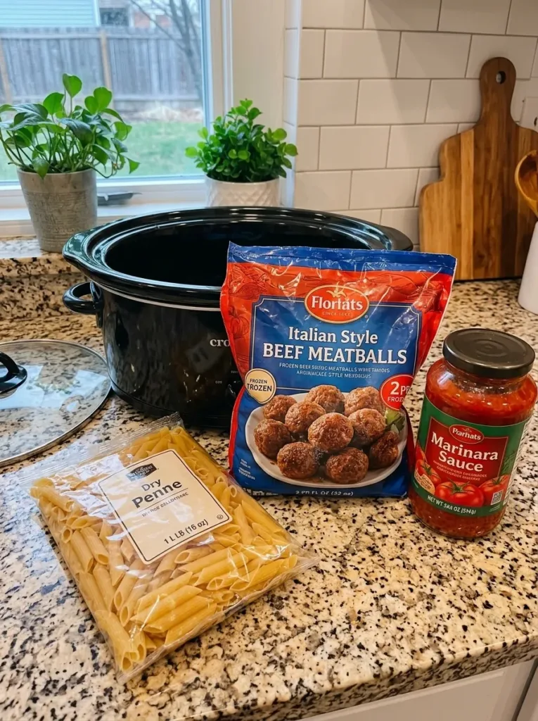 A delicious serving of Crockpot Meatball Penne with garnished herbs.