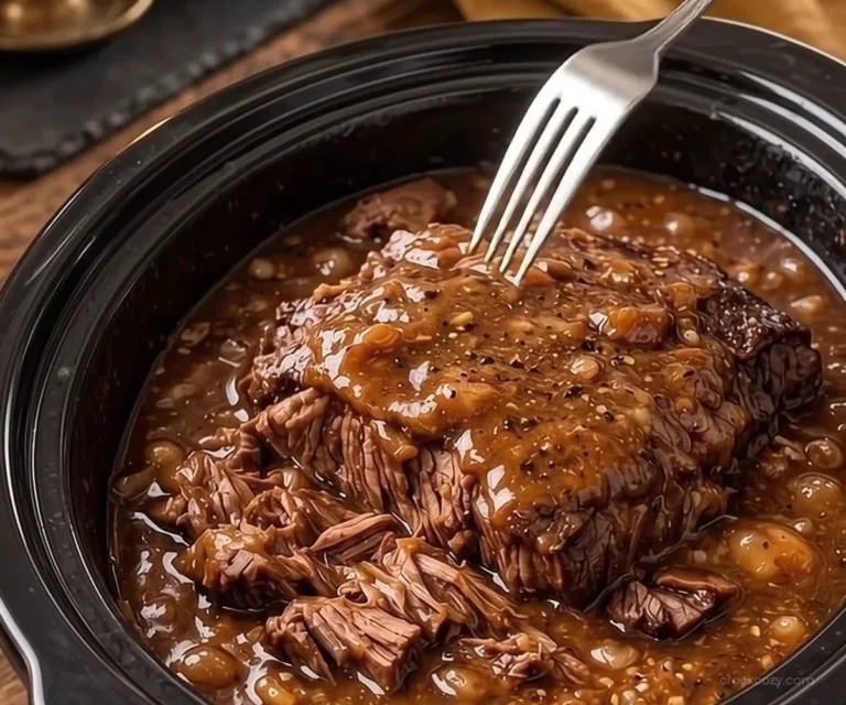 Slow cooker pot roast with French onion gravy served on a plate